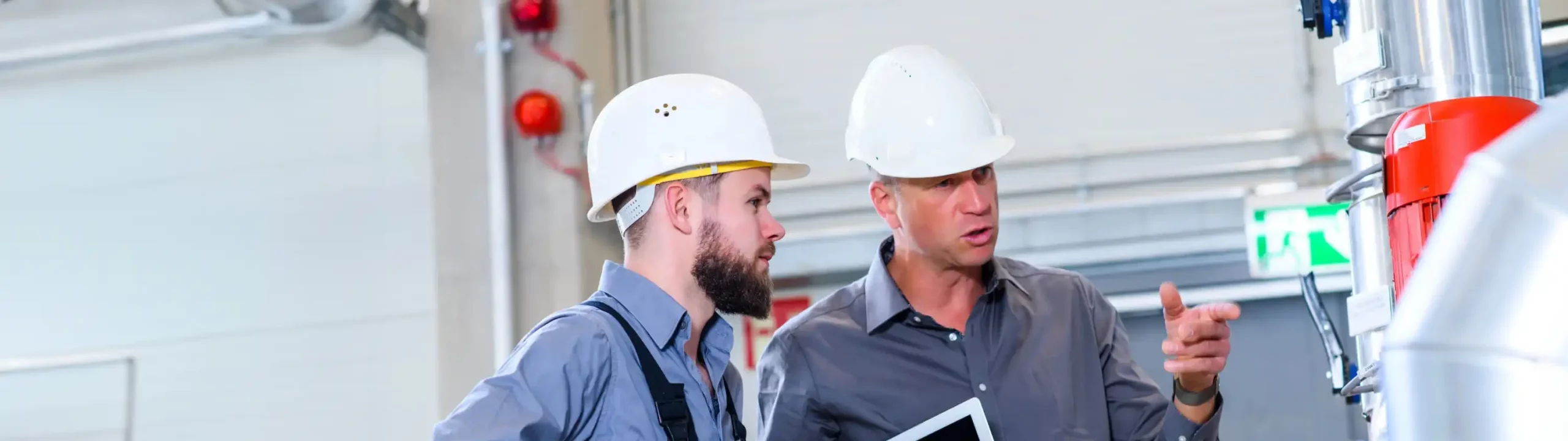 Zwei Fiel Evaluation Agents bei der Arbeit. Mit weißem Helm.